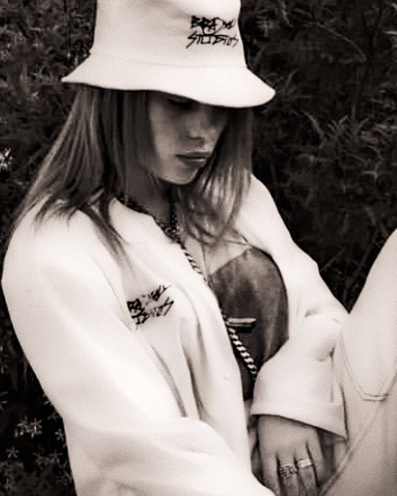 Billie Eilish in Brashy Studios bucket hat and jacket.