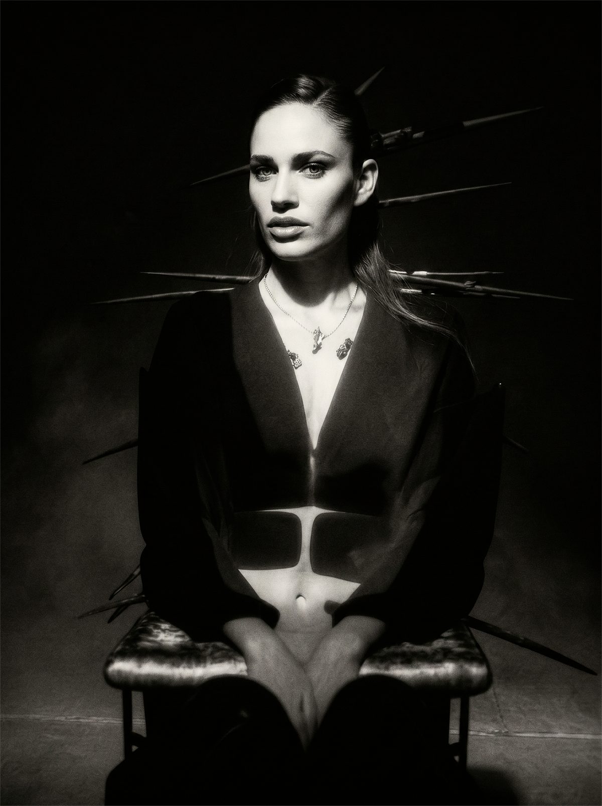 NIIA — a commissioned black-and-white editorial: a seated figure haloed by radial light